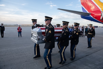 Members of the Minnesota National Guard funeral honors team carry the casket of U.S. Army Staff Sgt. Donald Duchene, a World War II service member killed in action in 1943, during a planeside honors ceremony Sept. 30, 2022. Since its inception in 2006, the Minnesota Military Funeral Honors team has conducted more than 55,000 funerals for veterans of all branches.