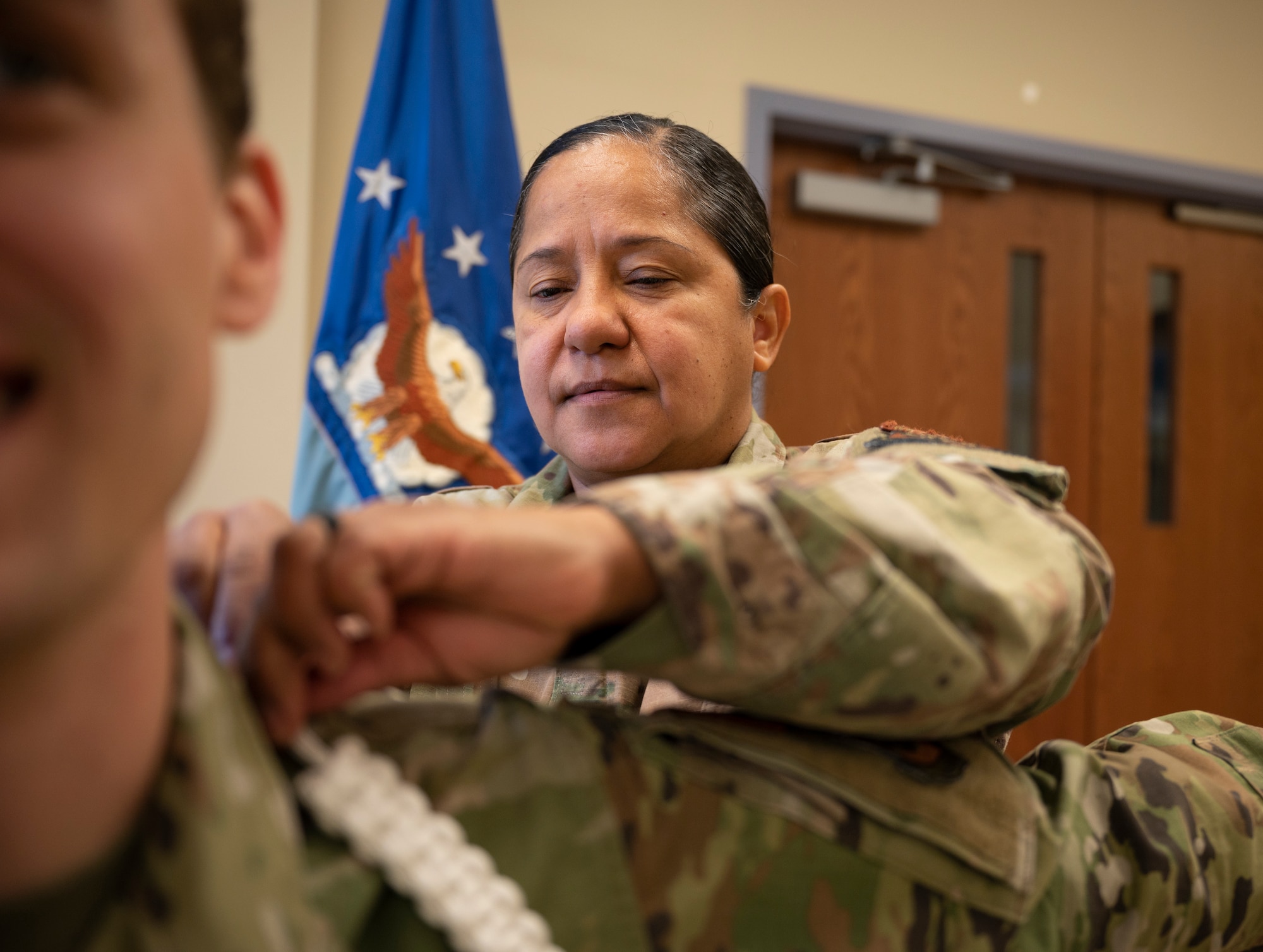 Tech. Sgt. Nancy Niles, 436th Airlift Wing Religious Affairs Airman, mounts an aiguillette at Chapel 1 on Dover Air Force Base, Delaware, Nov. 23, 2022. The 436th AW Chapel will introduce the White Rope program Dec. 2022, extending the chapel’s reach across the base through liaisons trained in crisis intervention. (U.S. Air Force photo by Airman 1st Class Amanda Jett)