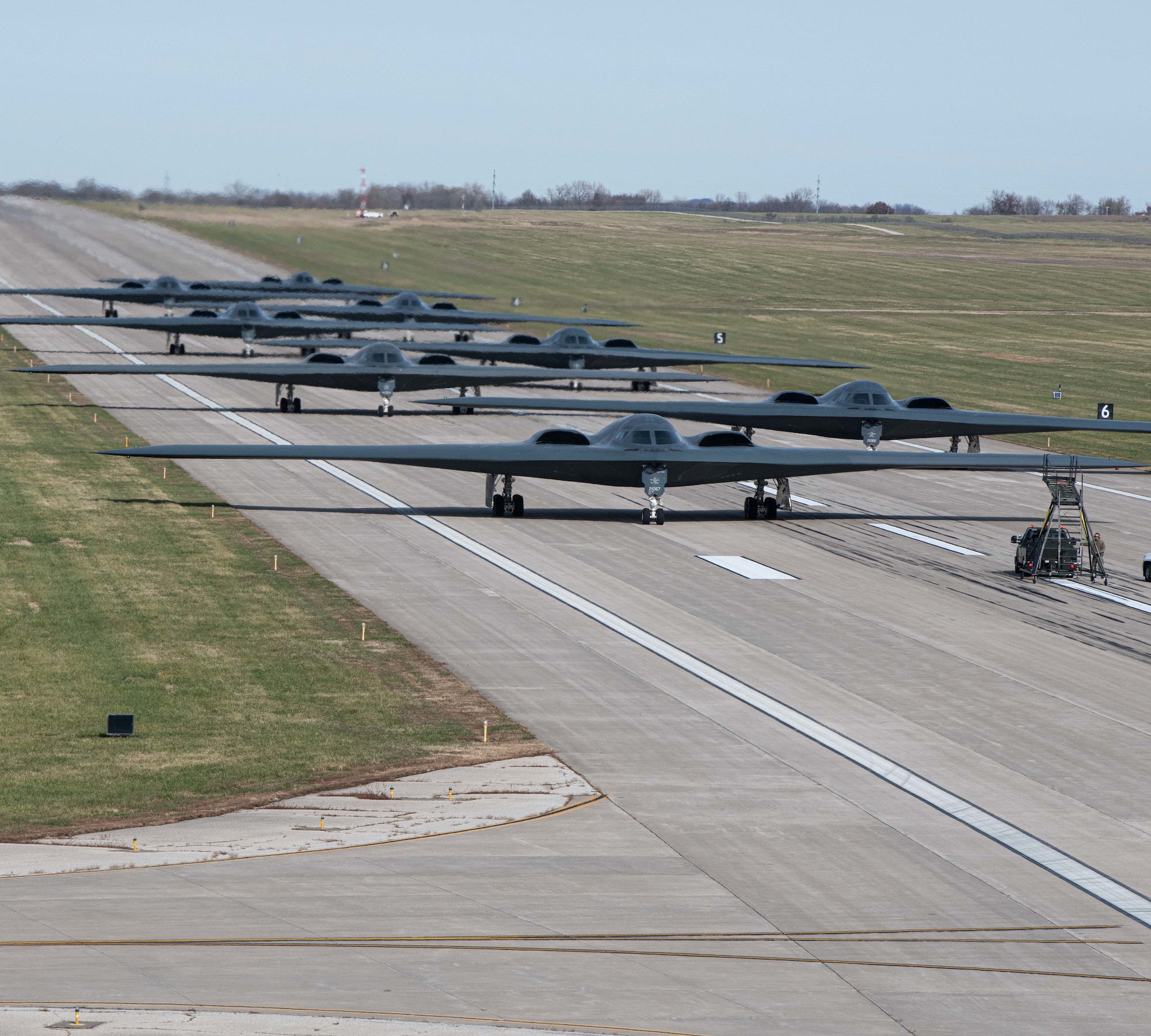 B-2 Spirit stealth bombers assigned to Whiteman Air Force Base taxi and take-off during exercise Spirit Vigilance on Whiteman Air Force Base, Missouri November 7, 2022. Routine exercises like Spirit Vigilance assure our allies and partners that Whiteman Air Force Base is ready to execute nuclear operations and global strike anytime, anywhere. (U.S. Air Force photo by Airman 1st Class Bryson Britt)