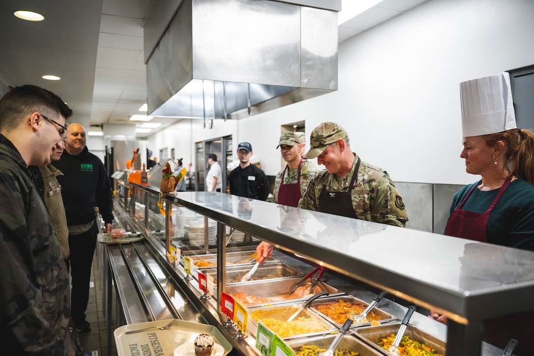 Airmen receiving Thanksgiving meal from leadership in DFAC