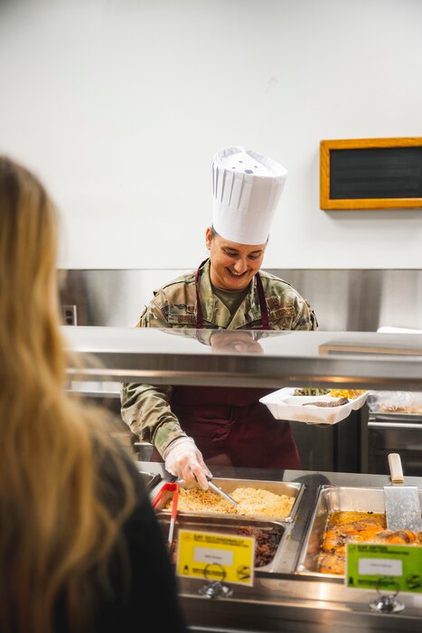 Airmen receiving Thanksgiving meal from leadership in DFAC