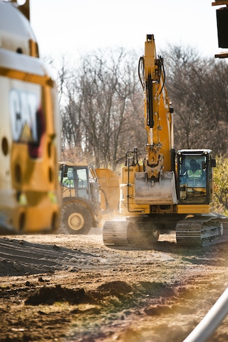 A worker drives an excavator Nov. 21 toward a pile of gravel at Wright-Patterson Air Force Base, Ohio.