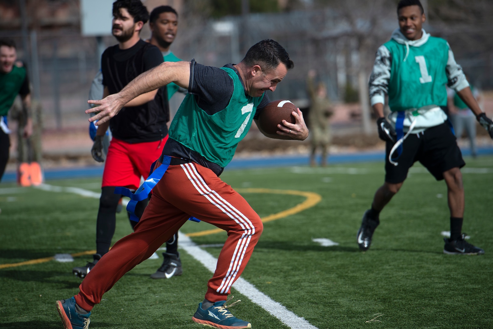 Man with football running