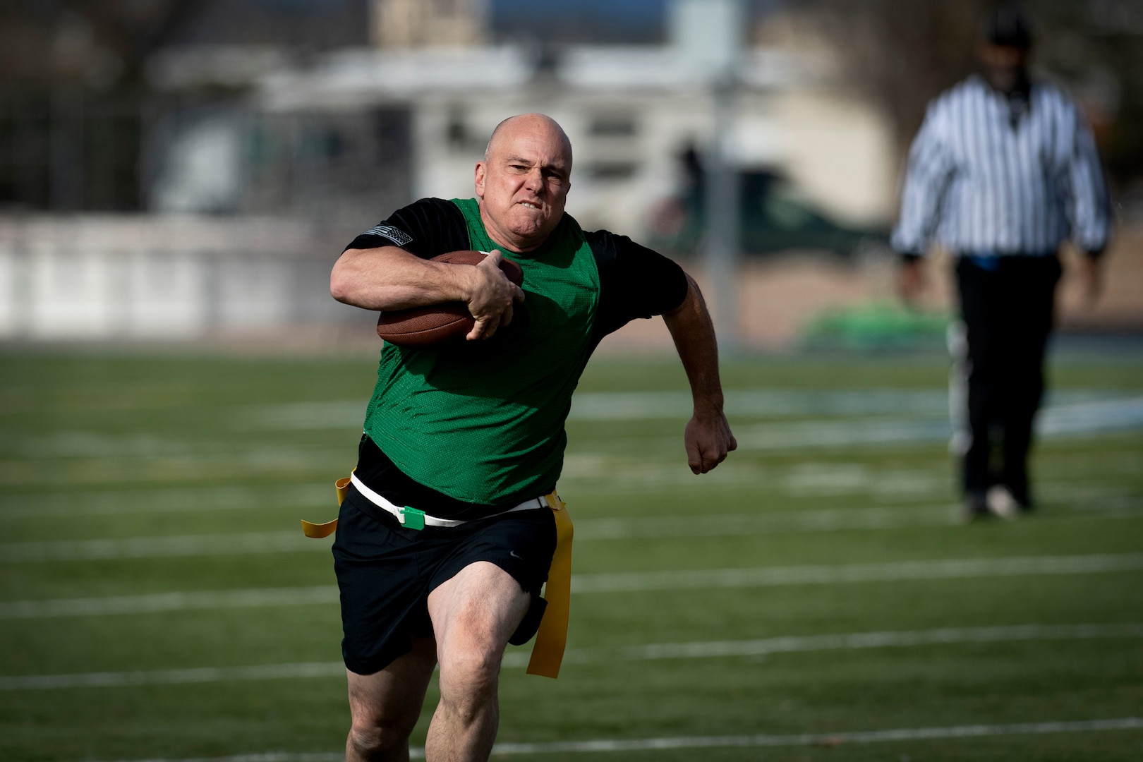 Man running while carrying football