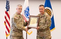 Lt. Col. Trond Ruud and Col. Scott Madore pose with the Product Manager Small Arms Fire Control (PdM SAFC) organizational charter during an assumption of charter ceremony that established PdM SAFC on Fort Belvoir, August 12. The establishment of the product management office concludes phase three of Program Executive Office (PEO) Soldier’s reorganization efforts, following the disestablishment of Project Manager, Soldier Maneuver and Precision Targeting in July.