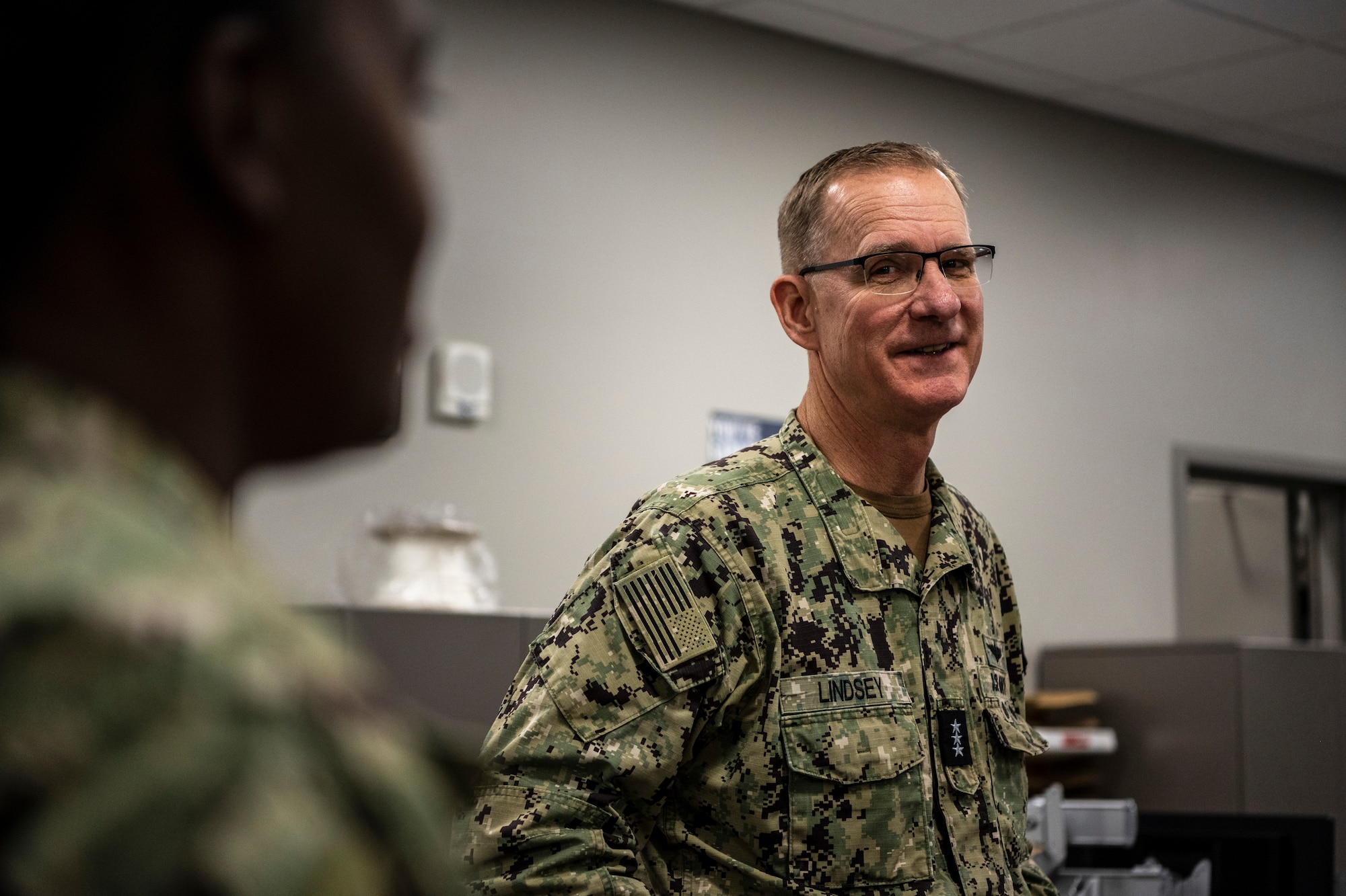 Navy personnel discuss aviation maintenance.