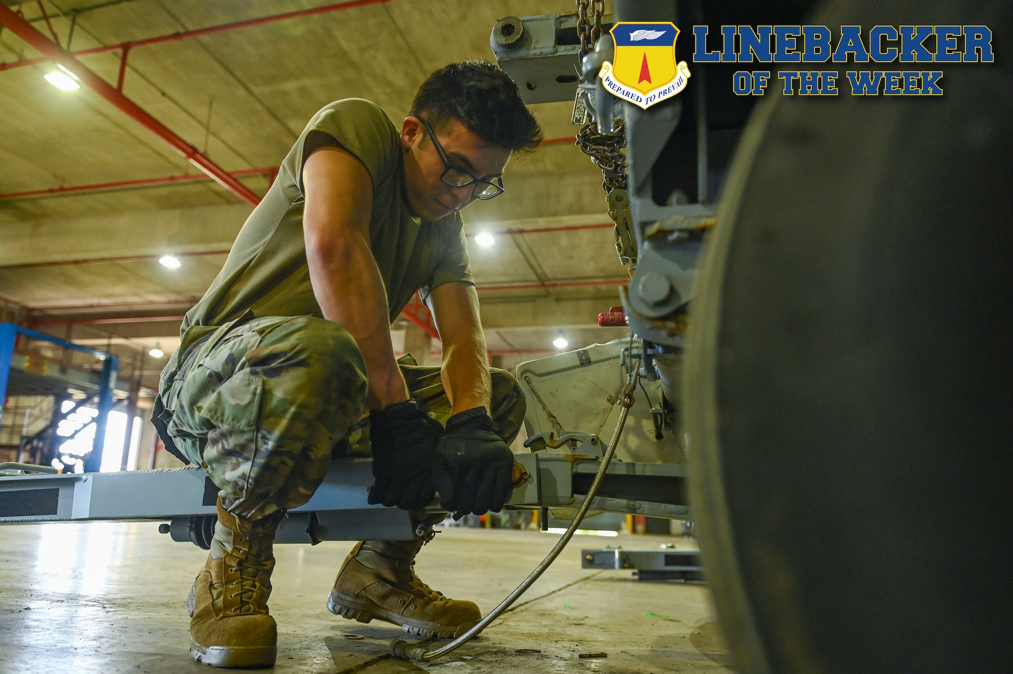 Airman tightens a bolt on a trailer