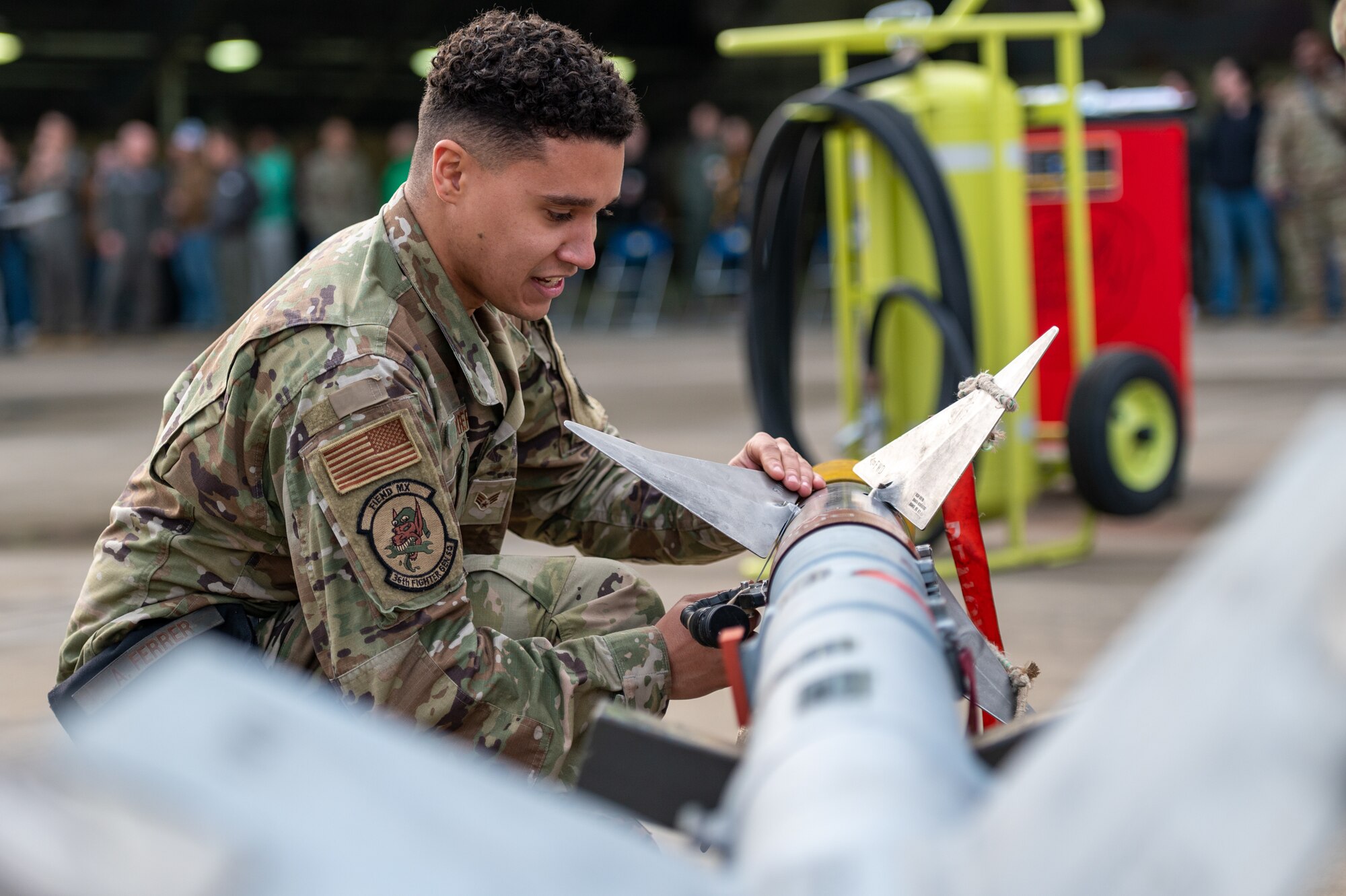 U.S. Air Force Senior Airman Angel Ferrer, 36th Fighter Generation Squadron weapons load crew member, inspects an AIM-9L/M Sidewinder before it is loaded onto an F-16 Fighting Falcon during a weapons load crew of the quarter competition