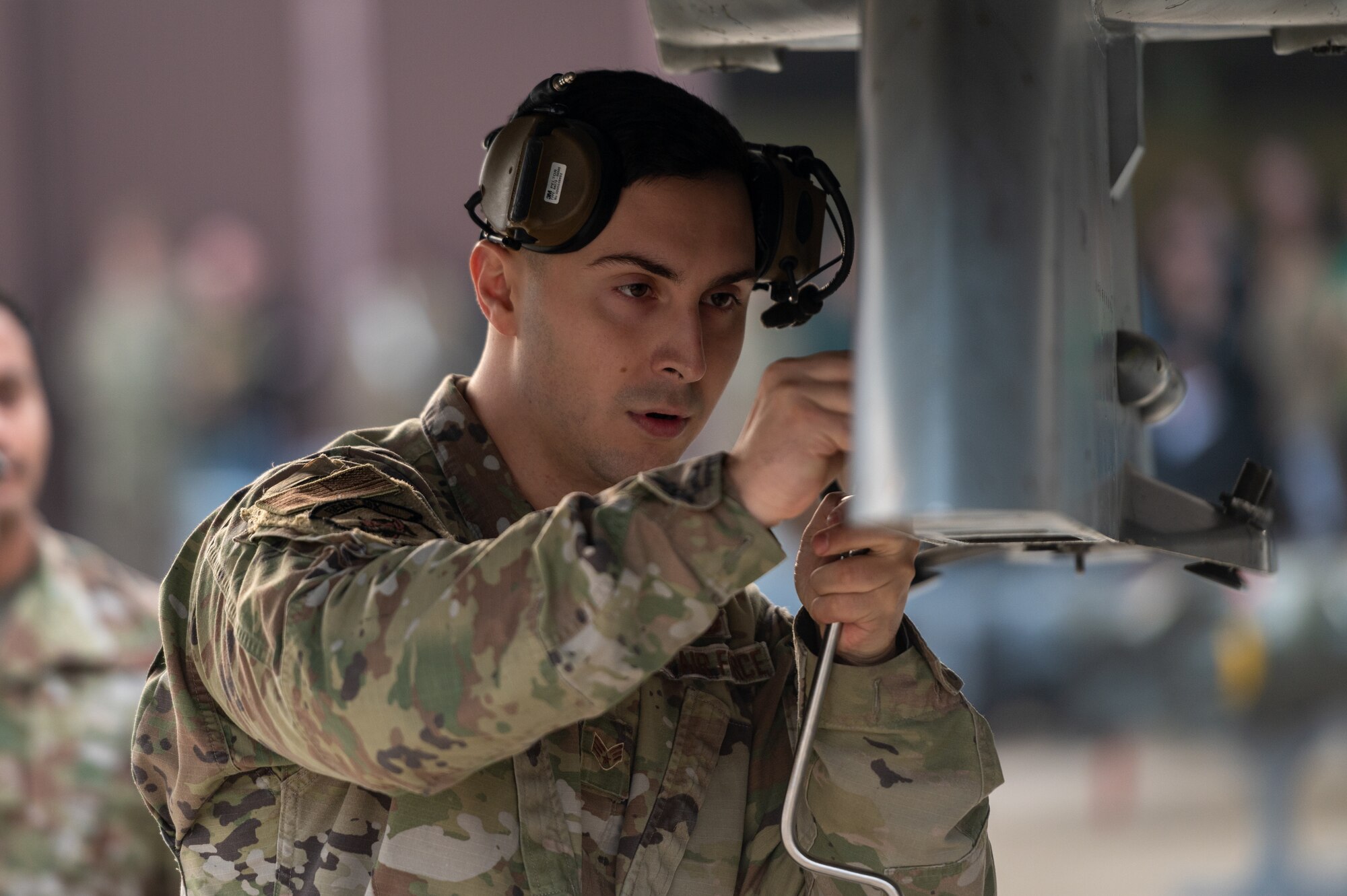 U.S. Air Force Senior Airman Jac Bobadilla, 36th Fighter Generation Squadron weapons load crew member, prepares an F-16 Fighting Falcon to receive munitions during a weapons load crew of the quarter competition