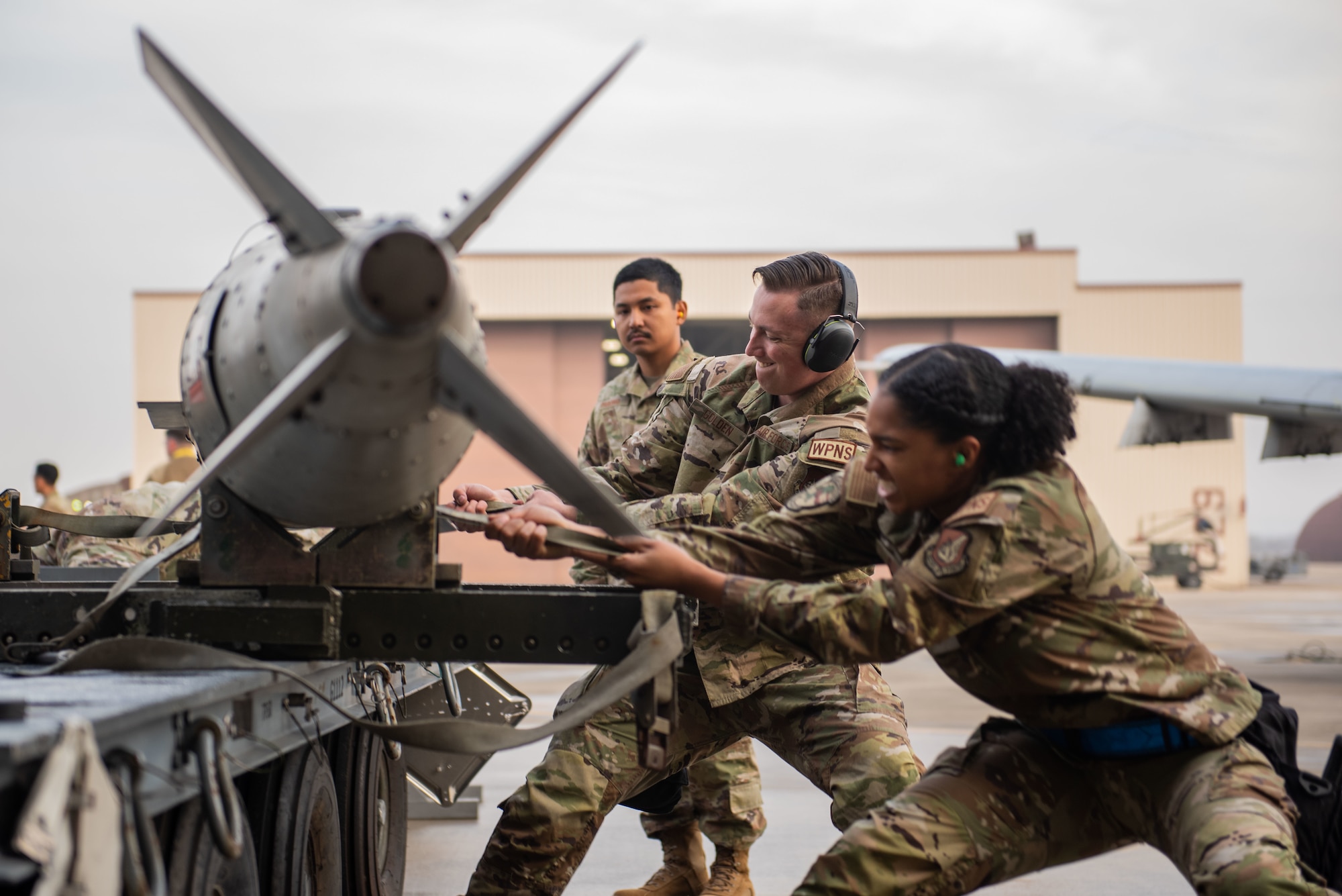 U.S. Air Force Staff Sgt. Kenyah Smith and Senior Airman Dillon Golden, 25th Fighter Generation Squadron weapons load crew members, prepare a GBU-31V3 munition to load onto an A-10C Thunderbolt II during a weapons load crew of the quarter competition