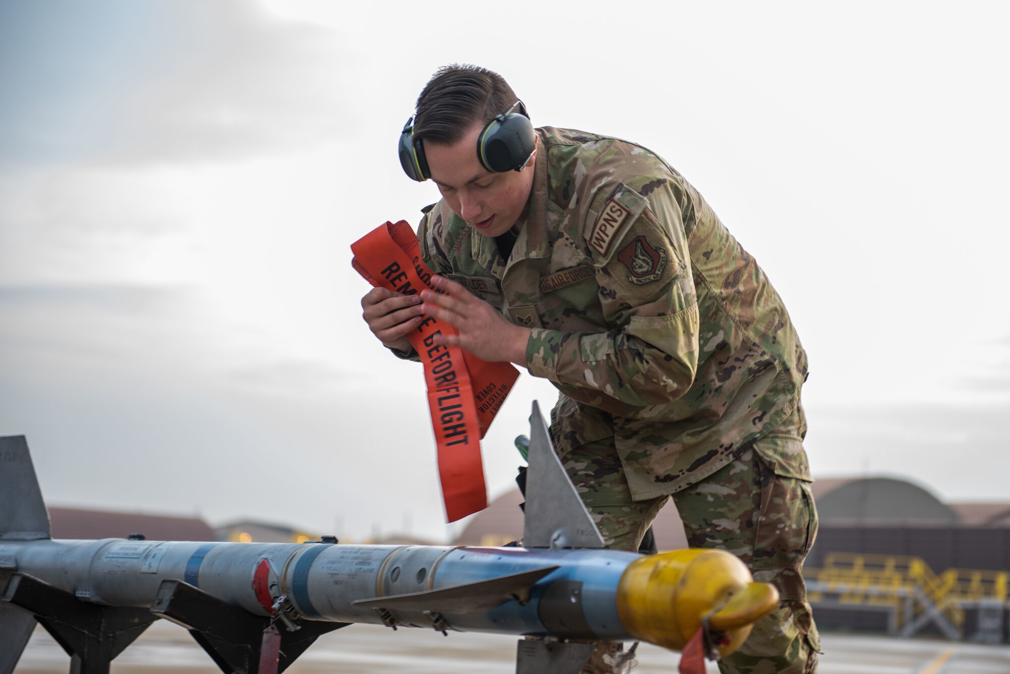 U.S. Air Force Senior Airman Dillon Golden, 25th Fighter Generation Squadron weapons load crew member, competes in a weapons load crew of the quarter competition