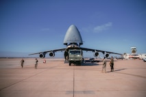 U.S. Marines with 1st Landing Support Battalion, 1st Marine Logistics Group, I Marine Expeditionary Force work with Airmen from the 22nd Airlift Squadron, 60th Operations Group, 60th Air Mobility Wing to on-load the MAC 50 all-terrain crane onto a C5-M Super Galaxy at Marine Corps Air Station Miramar, California, Oct. 28, 2022. Marine Corps Systems Command has been modernizing the legacy cranes as part of a Service Life Extension Program, which includes upgraded controls and overhauled engines. (U.S. Marine Corps photo by Chief Warrant Officer 2 Eric LaClair)