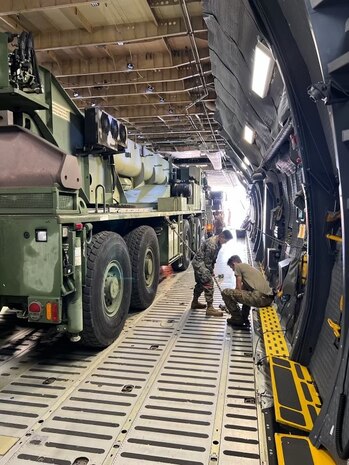 U.S. Marines with 1st Landing Support Battalion, 1st Marine Logistics Group, I Marine Expeditionary Force work with Airmen from the 22nd Airlift Squadron, 60th Operations Group, 60th Air Mobility Wing to on-load a MAC 50 all-terrain crane onto a C5-M Super Galaxy at Columbus Air Force Base, Mississippi, Oct. 30, 2022. Marine Corps Systems Command has been modernizing the legacy cranes as part of the Service Life Extension Program, which includes upgraded controls and overhauled engines. (U.S. Marine Corps photo by MSgt Delsean Barrow)