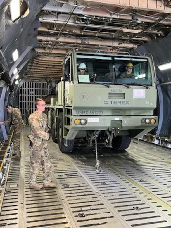U.S. Marines with 1st Landing Support Battalion, 1st Marine Logistics Group, I Marine Expeditionary Force work with Airmen from the 22nd Airlift Squadron, 60th Operations Group, 60th Air Mobility Wing to on-load a MAC 50 all-terrain crane onto a C5-M Super Galaxy at Columbus Air Force Base, Mississippi, Oct. 30, 2022. Marine Corps Systems Command has been modernizing the legacy cranes as part of the Service Life Extension Program, which includes upgraded controls and overhauled engines. (U.S. Marine Corps photo by MSgt Delsean Barrow)