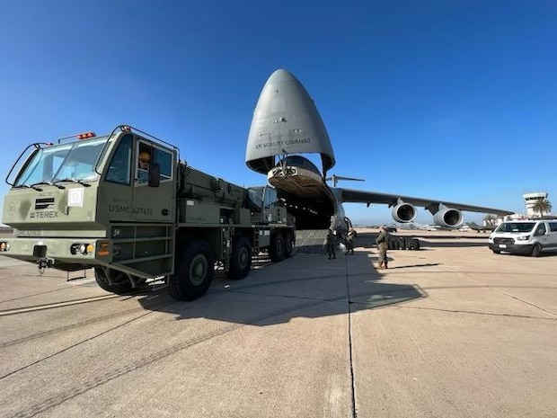 U.S. Marines with 1st Landing Support Battalion, 1st Marine Logistics Group, I Marine Expeditionary Force work with Airmen from the 22nd Airlift Squadron, 60th Operations Group, 60th Air Mobility Wing to on-load a MAC 50 all-terrain crane onto a C5-M Super Galaxy at Columbus Air Force Base, Mississippi, Oct. 30, 2022. Marine Corps Systems Command has been modernizing the legacy cranes as part of the Service Life Extension Program, which includes upgraded controls and overhauled engines. (U.S. Marine Corps photo by MSgt Delsean Barrow)