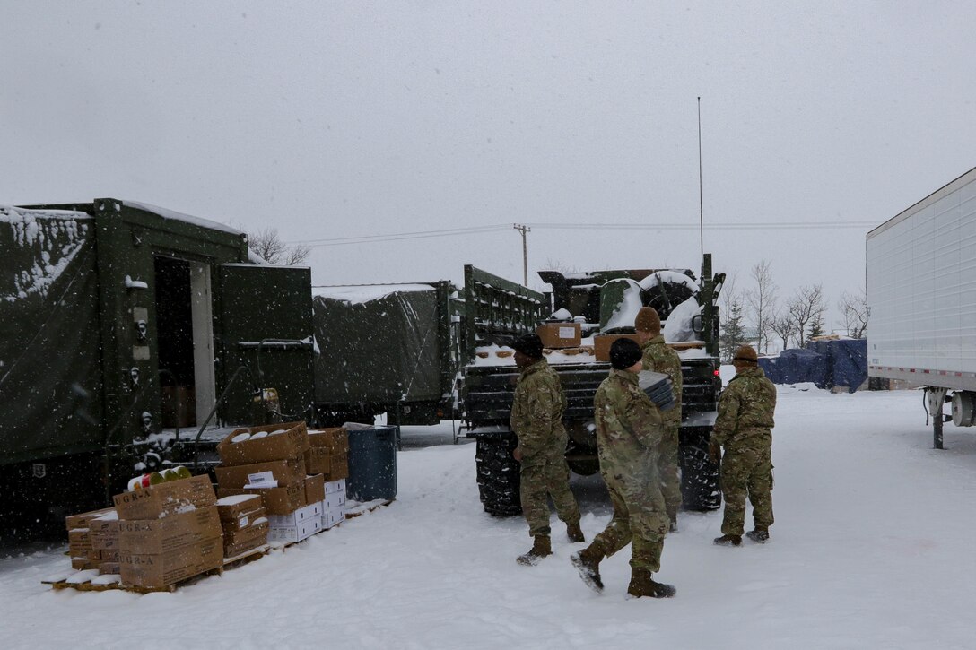 Soldiers with 4th Brigade Combat Team, 25th Infantry Division, US Army Alaska load meals into the back of a Light Medium Tactical Vehicle at the Intermediate Staging Base near Fort Greely, AK, March 10, 2022. Joint Pacific Multinational Readiness Center 22-02, executed in Alaska with its Arctic environment, builds Soldiers and leaders into a team of skilled, tough, alert, and adaptive warriors capable of fighting and winning anywhere. (Photo by Staff Sgt. Christopher B. Dennis/USARAK PAO NCO)