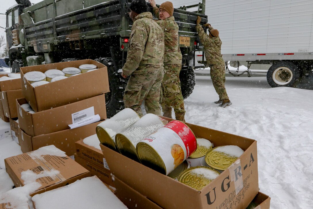 Soldiers with 4th Brigade Combat Team, 25th Infantry Division, US Army Alaska load meals and food into the back of a Light Medium Tactical Vehicle at the Intermediate Staging Base near Fort Greely, AK March 10, 2022. Joint Pacific Multinational Readiness Center 22-02, executed in Alaska with its Arctic environment, builds Soldiers and leaders into a team of skilled, tough, alert, and adaptive warriors capable of fighting and winning anywhere. (Photo by Staff Sgt. Christopher B. Dennis/USARAK PAO NCO)