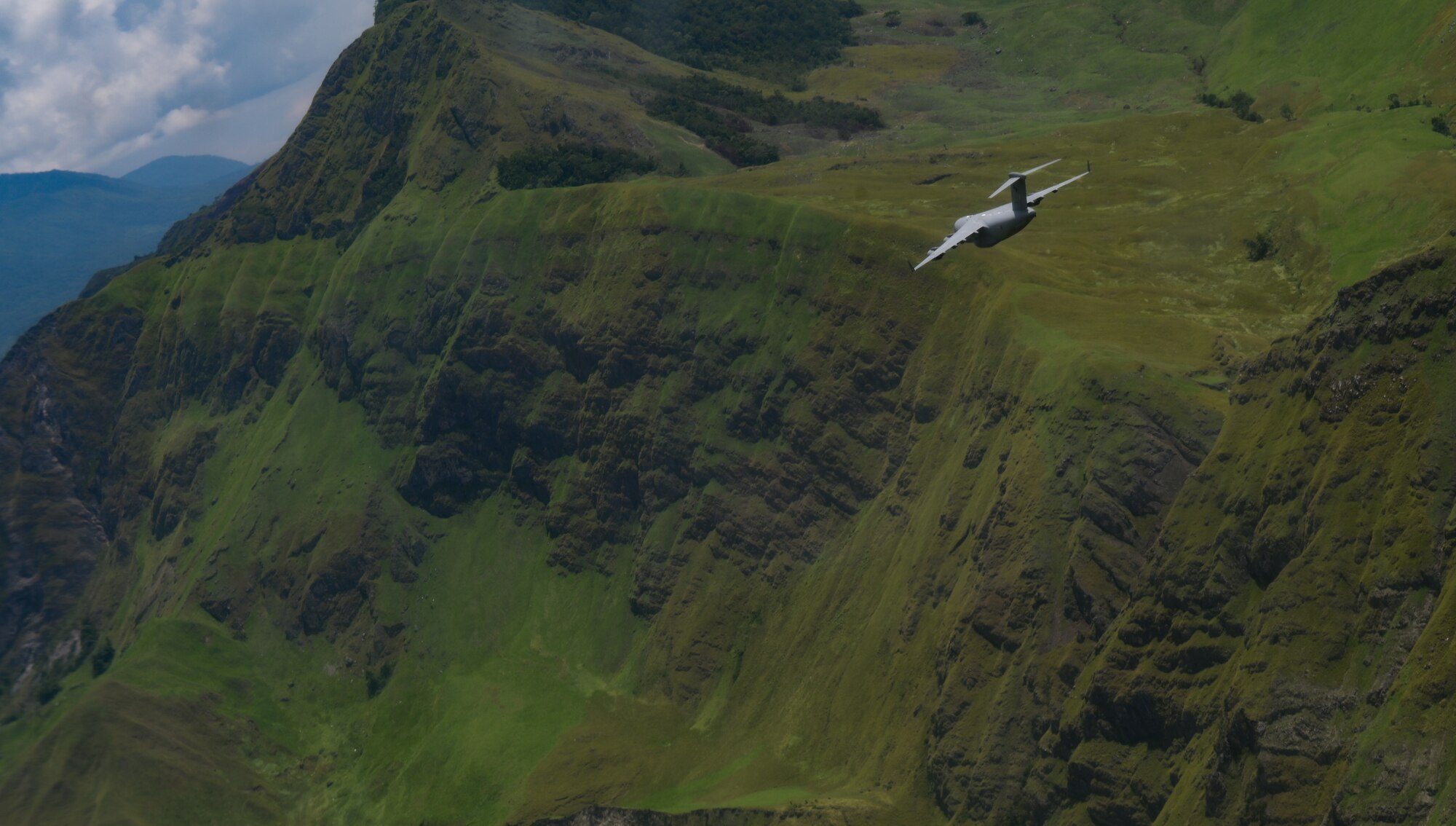 A Royal Australian Air Force C-17 Globemaster III flies in a 2-ship formation with a U.S. Air Force C-17 during Exercise Global Dexterity in the skies over Papua New Guinea, Nov. 18, 2022. Exercise Global Dexterity 2022 is being conducted at RAAF Base Amberley, and is designed to help develop the bilateral tactical airlift and airdrop capabilities of the USAF and the RAAF. Both the United States and Australia rely on the C-17A to provide strategic and tactical airlift across the Indo-Pacific region with its ability to provide short-notice and time-critical airlift support, making it essential during humanitarian assistance and disaster relief operations. (U.S. Air Force photo by Staff Sgt. Alan Ricker)