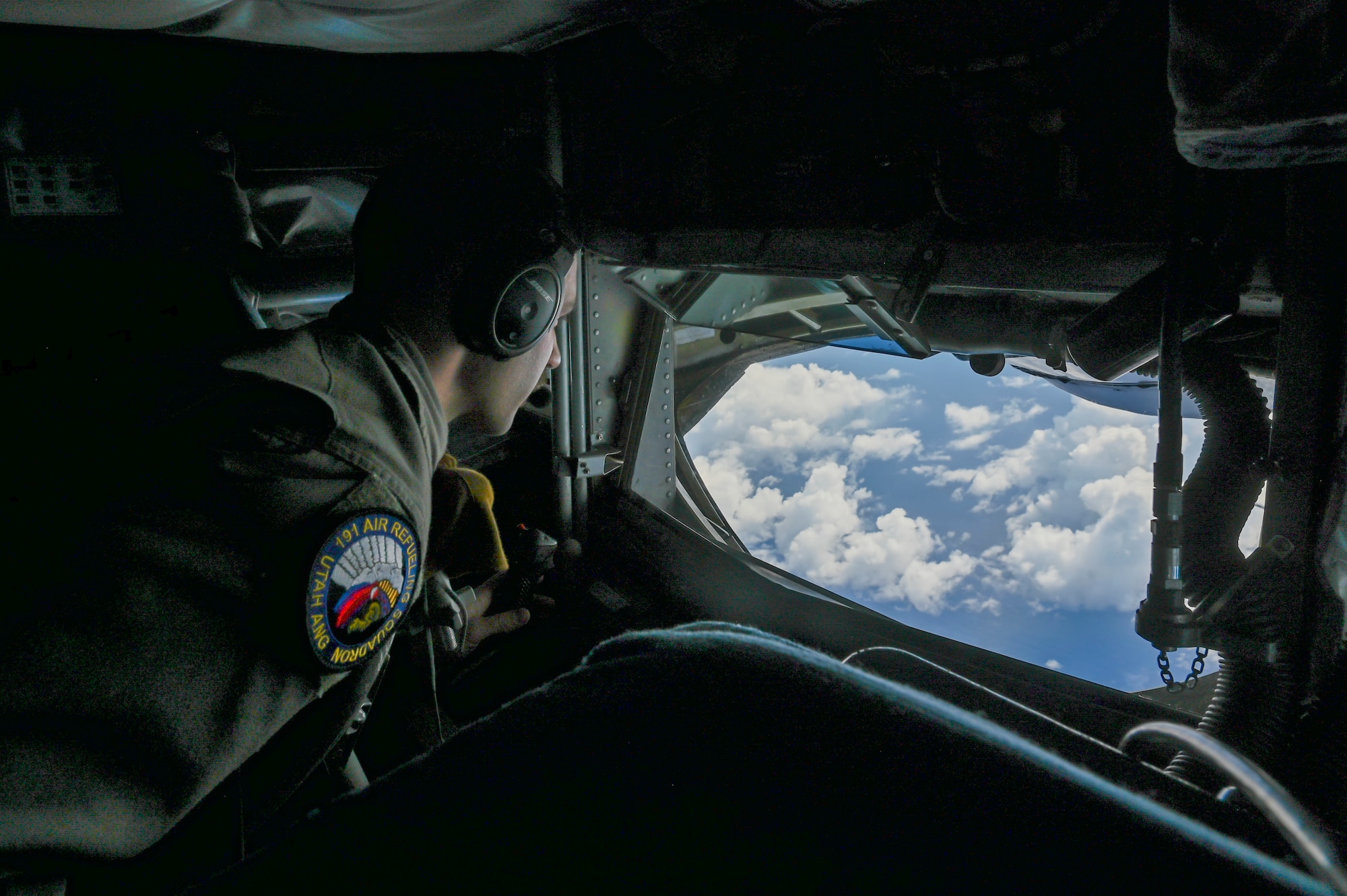 Airman looking out the window of a plane.