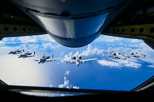 Airman looking out the window of a plane.