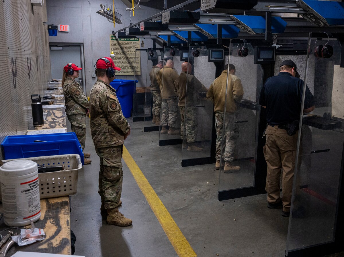 Airmen assigned to the 4th Fighter Wing and local law enforcement compete in the excellence-in-competition pistol match, at Seymour Johnson Air Force Base, North Carolina, Nov. 18, 2022. The EIC pistol match tested participants on their handling of a M-9 pistol, their response time and the efficiency of their shots when firing at 25-yard targets. (U.S. Air Force photo by Airman 1st Class Sabrina Fuller)