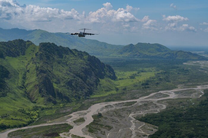 A Royal Australian Air Force C-17 Globemaster III flies in a 2-ship formation with a U.S. Air Force C-17 during Exercise Global Dexterity in the skies over Papua New Guinea, Nov. 18, 2022. Exercise Global Dexterity 2022 is being conducted at RAAF Base Amberley, and is designed to help develop the bilateral tactical airlift and airdrop capabilities of the USAF and the RAAF. Both the United States and Australia rely on the C-17A to provide strategic and tactical airlift across the Indo-Pacific region with its ability to provide short-notice and time-critical airlift support, making it essential during humanitarian assistance and disaster relief operations. (U.S. Air Force photo by Staff Sgt. Alan Ricker)