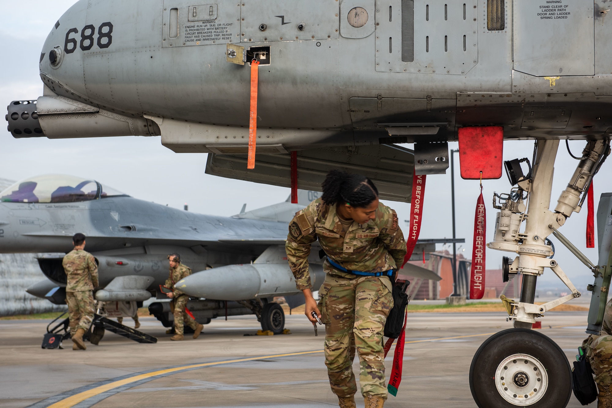 U.S. Air Force Airmen assigned to the 51st Maintenance Group participate in a weapons load crew of the quarter competition