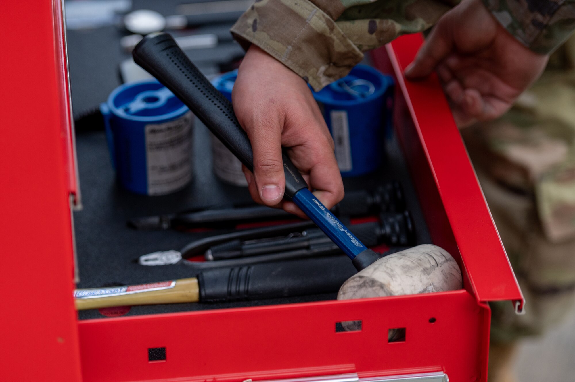 U.S. Air Force Airmen from a 36th Fighter Generation Squadron weapons load crew put away their tools during a weapons load crew of the quarter competition