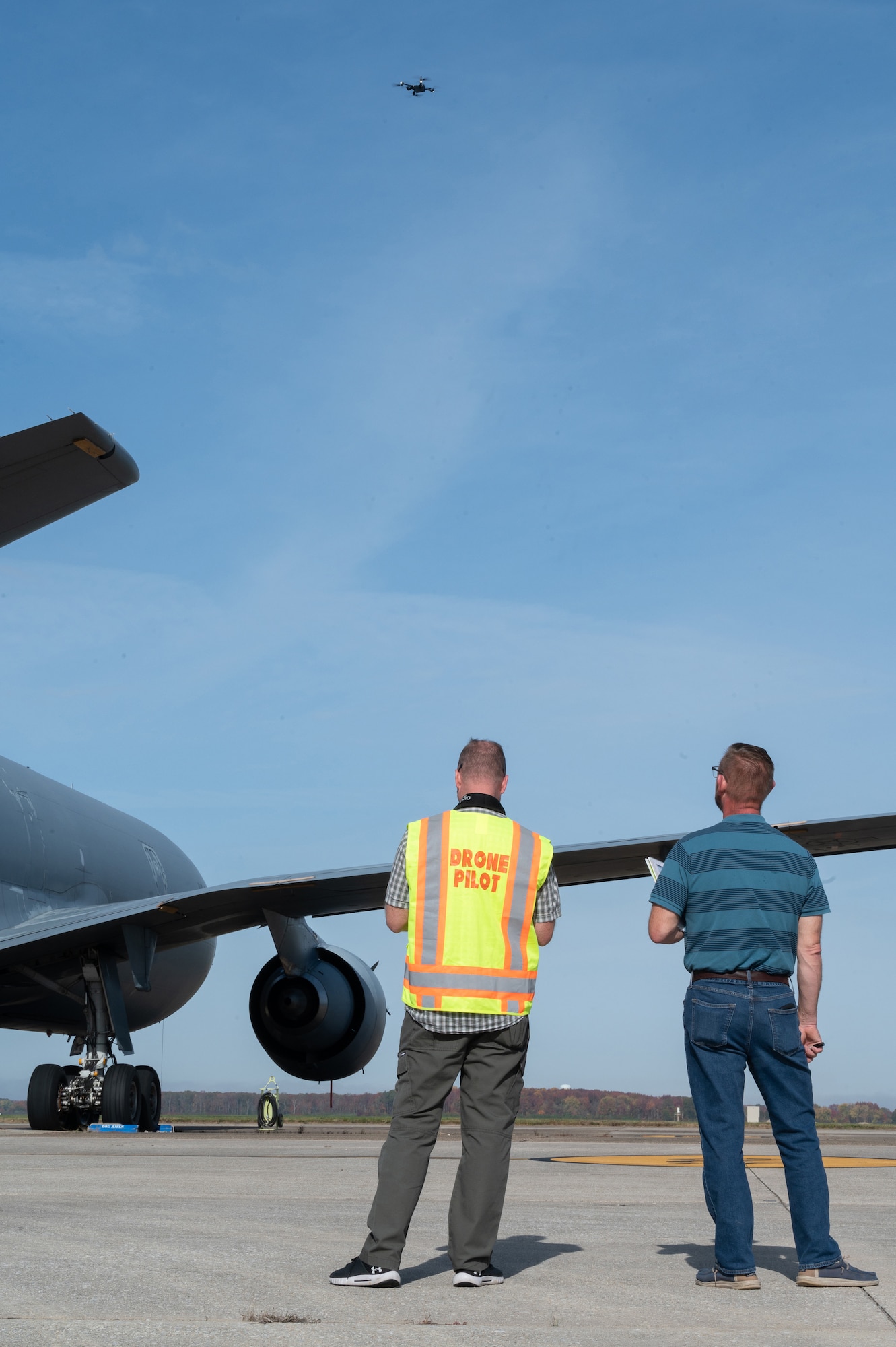 Ken Jones, left, 436th Mission Generation Group continuous process improvement manager, flies a Skydio X2D drone while Arnie Maas, right, 436th Airlift Wing government special advanced programs security officer, acts as a visual observer at Dover Air Force Base, Delaware, Nov. 4, 2022. Coordination with numerous base agencies and having a visual observer present is essential when flying a drone in restricted air space on and around Dover AFB. (U.S. Air Force photo by Mauricio Campino)