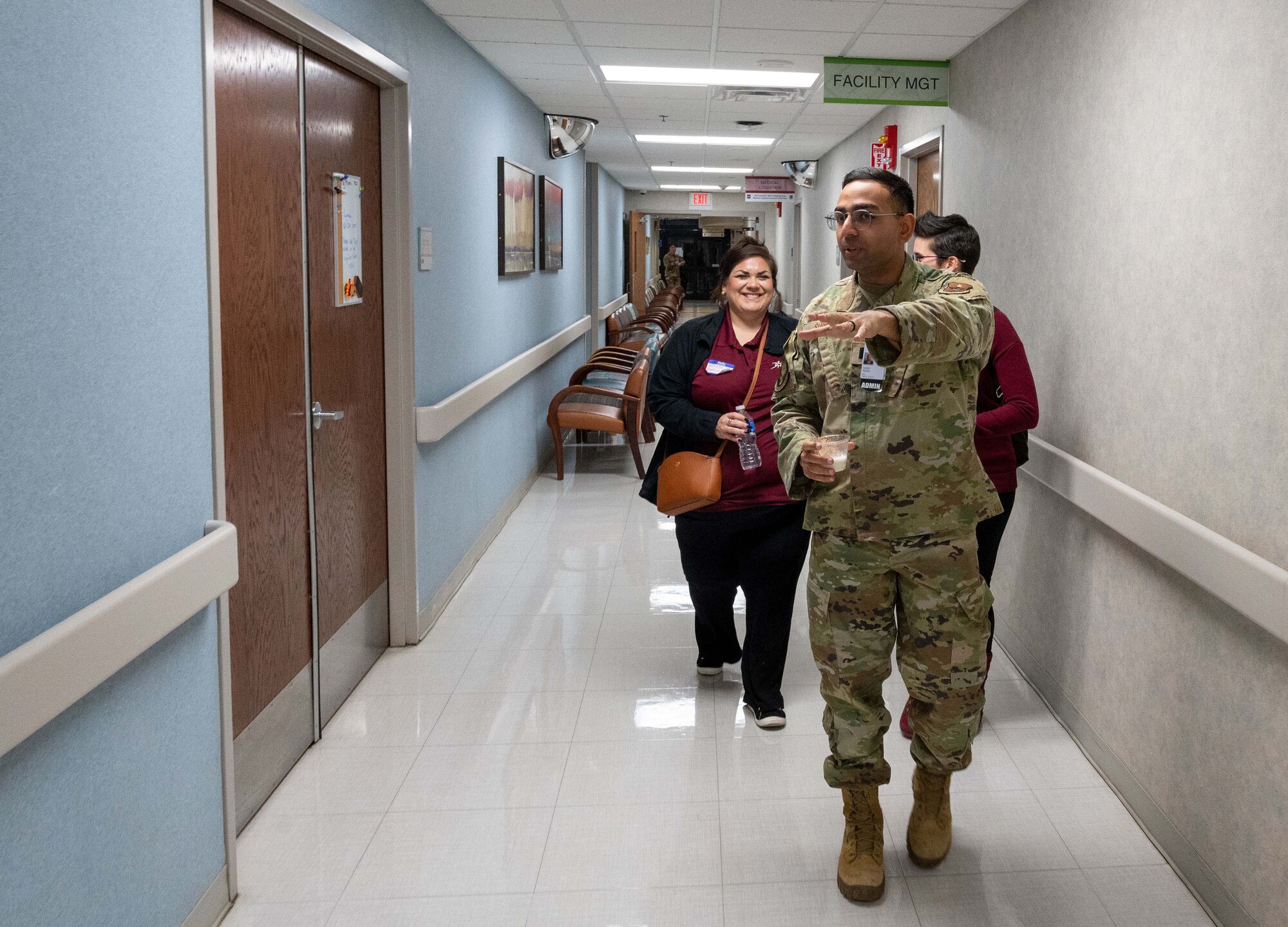 An Airman from the 47th Medical Group walks with medical service providers from the local community at the Humana Military Open House on Nov. 16, 2022, at Laughlin Air Force Base, Texas. The open house gives an opportunity for military medical service providers and local medical service providers to connect and build a better understanding of how everyone operates. (U.S. Air Force photo by Senior Airman Nicholas Larsen)