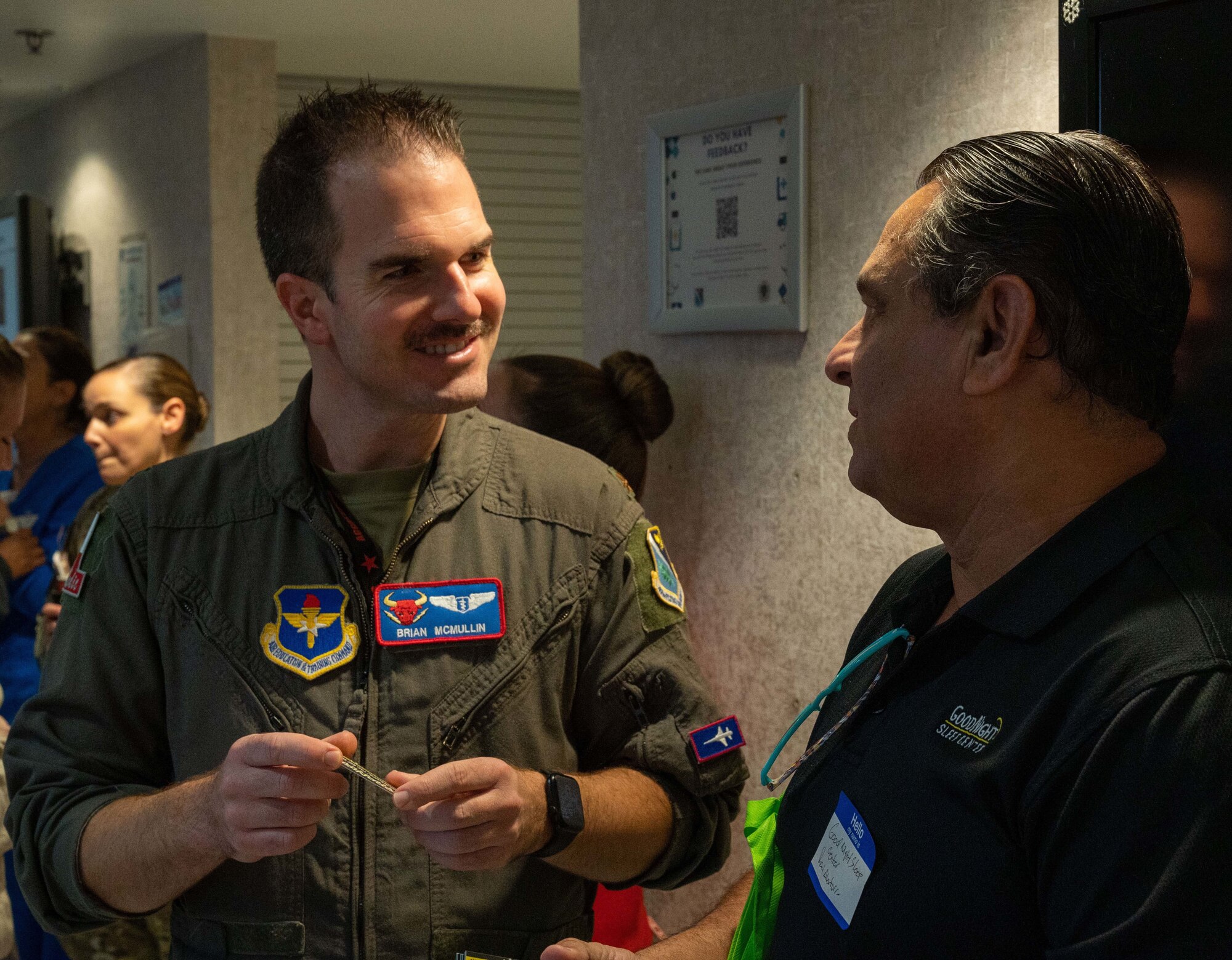 U.S. Air Force Major Brian McMullen, 47th Medical Group chief of aerospace medicine, talks with a medical service provider from the local community at the Humana Military Open House on Nov. 16, 2022, at Laughlin Air Force Base, Texas. The open house gives an opportunity for military medical service providers and local medical service providers to connect and build a better understanding of how everyone operates.  (U.S. Air Force photo by Senior Airman Nicholas Larsen)