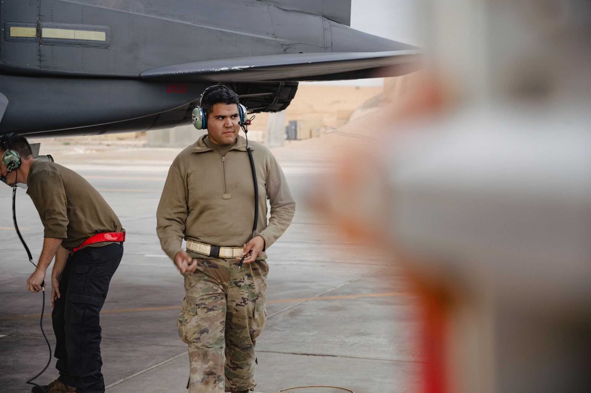 Senior Airman Hector J. Gomez, Jr., 332d Expeditionary Logistics Readiness Squadron Fuels Management Flight, prepares to view an aircraft launch as part of the “Maintainer for a Day” program at an undisclosed location, Nov. 10, 2022. Maintainer for a Day is an initiative that pairs Airmen across a variety of career fields with members of aircraft maintenance shops for a hands-on learning experience with F-15E Strike Eagle fighter jets. (U.S. Air Force photo by Tech. Sgt. Richard Mekkri)