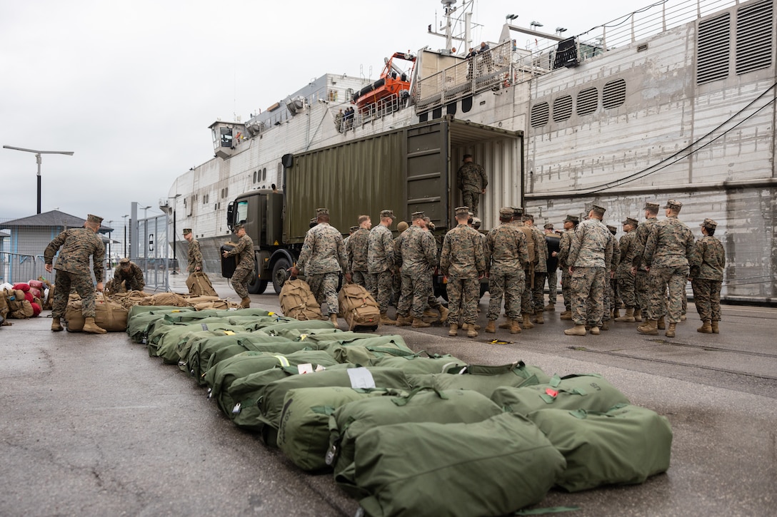 U.S. Marines assigned to II Marine Expeditionary Force unload baggage before boarding the Spearhead-class expeditionary fast transport USNS Trenton (T-EPF 5) in Ljubljana, Slovenia, Nov. 16, 2022. Marines assigned to II MEF, based out of Camp Lejeune, North Carolina, embarked aboard USNS Trenton to improve interoperability while refining the U.S. capability to rapidly deploy forces aboard U.S. Navy expeditionary fast transport vessels.