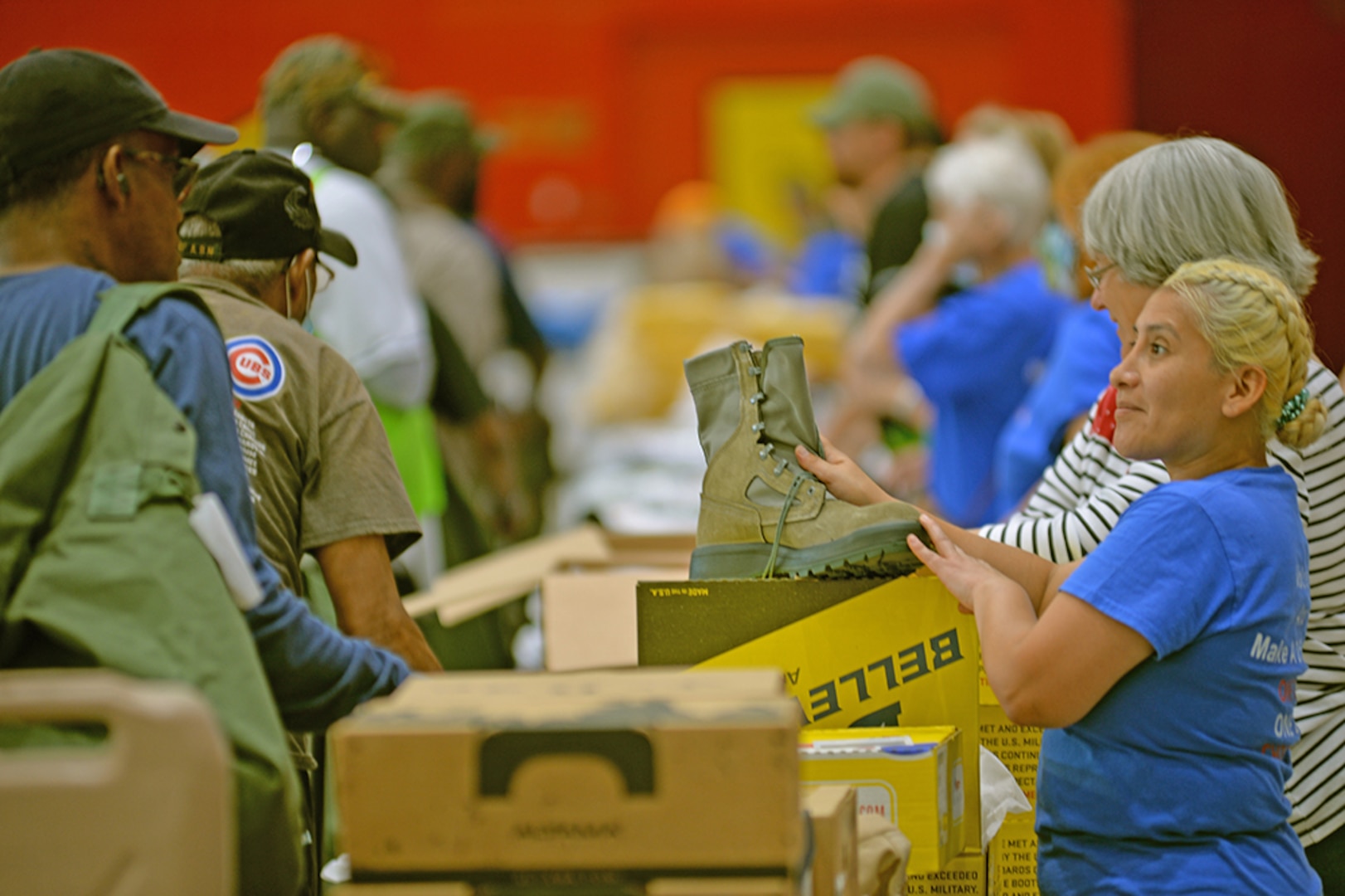 A volunteer hands out free boots in a surplus property line.