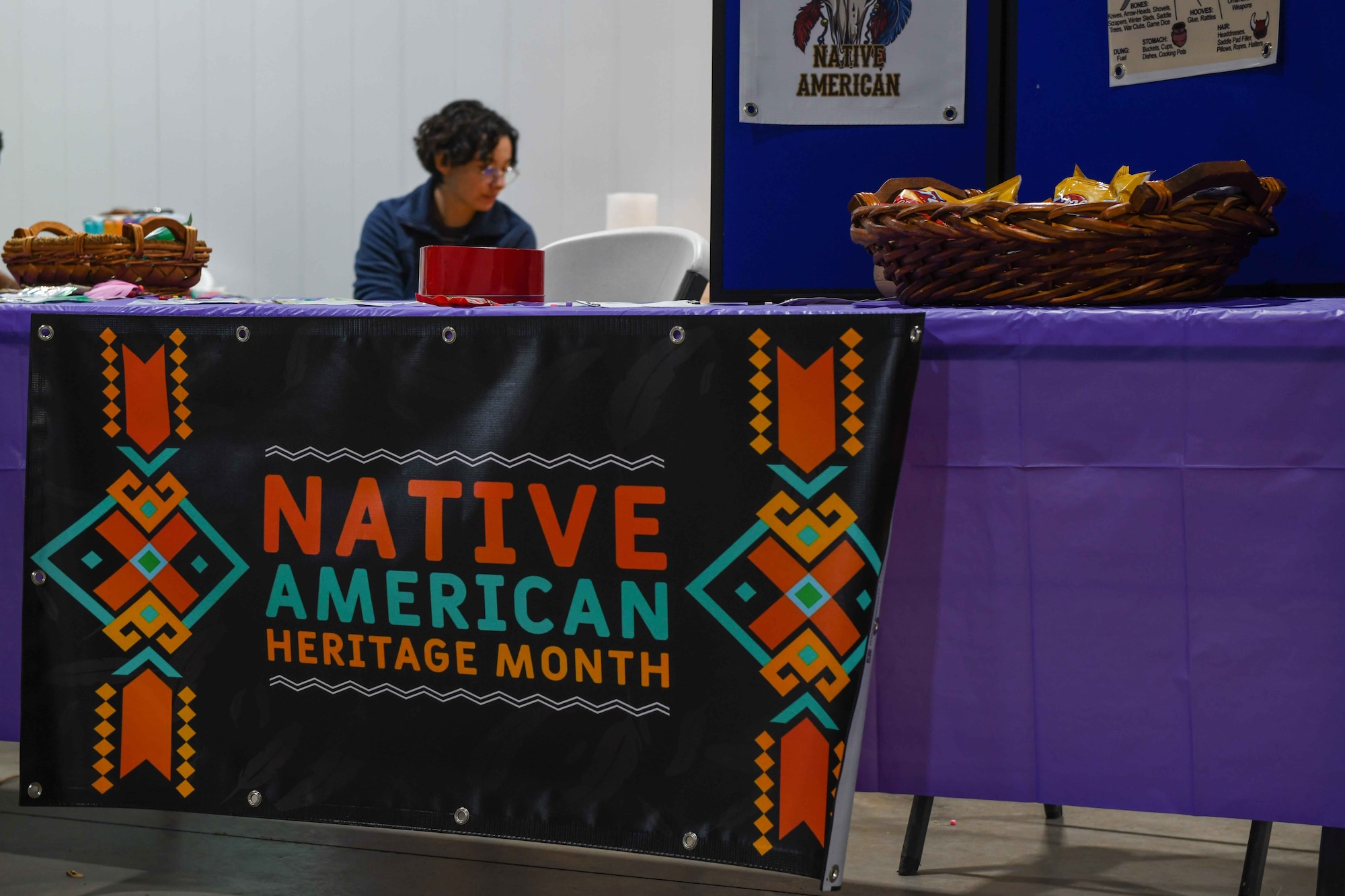 A booth at the Native American Heritage Month Celebration filled with chips, candy and stickers welcomes visitors at the Jackson County Expo Center on Nov. 19, 2022, in Altus, Oklahoma. Many booths had poster boards with paintings and facts about Native Americans around the local area, as well as pottery, clothes, and other artifacts. (U.S. Air Force photo by Airman 1st Class Kari Degraffenreed)