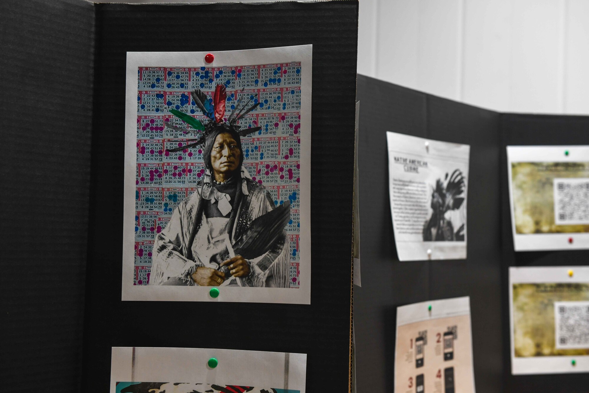 An illustration of a Native American hangs on a board in one of the booths displayed at the Native American Heritage celebration at the Jackson County Expo Center on Nov. 19, 2022, in Altus, Oklahoma. Vendors stood beside the posters ready to discuss information about local tribes and reservations. (U.S. Air Force photo by Airman 1st Class Kari Degraffenreed)