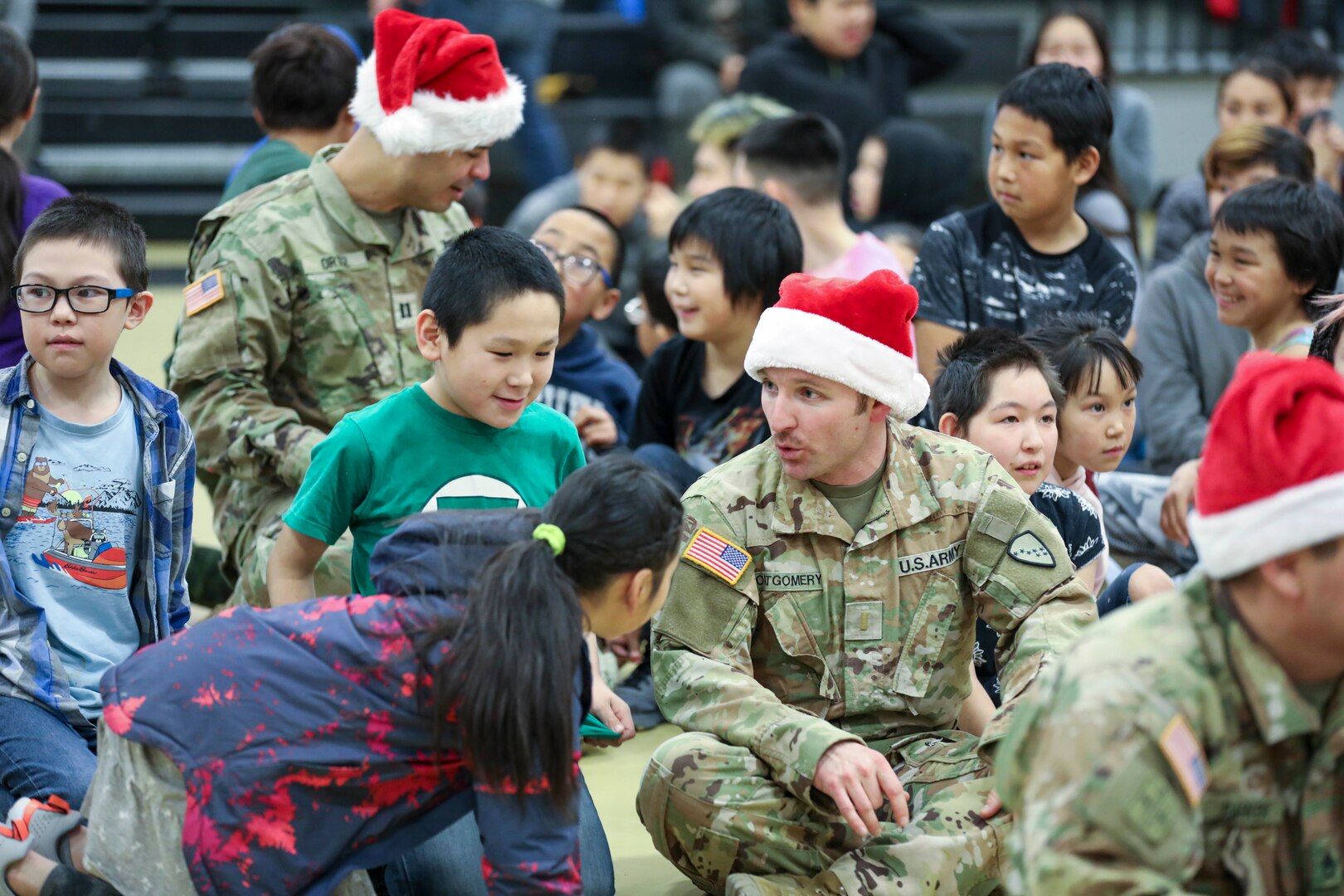 Alaska Army National Guard 2nd Lt. Ryan Montgomery, a pilot with 2nd Battalion, 211th Aviation Regiment (General Support Aviation Battalion), visits with children during Operation Santa Claus in Scammon Bay Nov. 16, 2022.