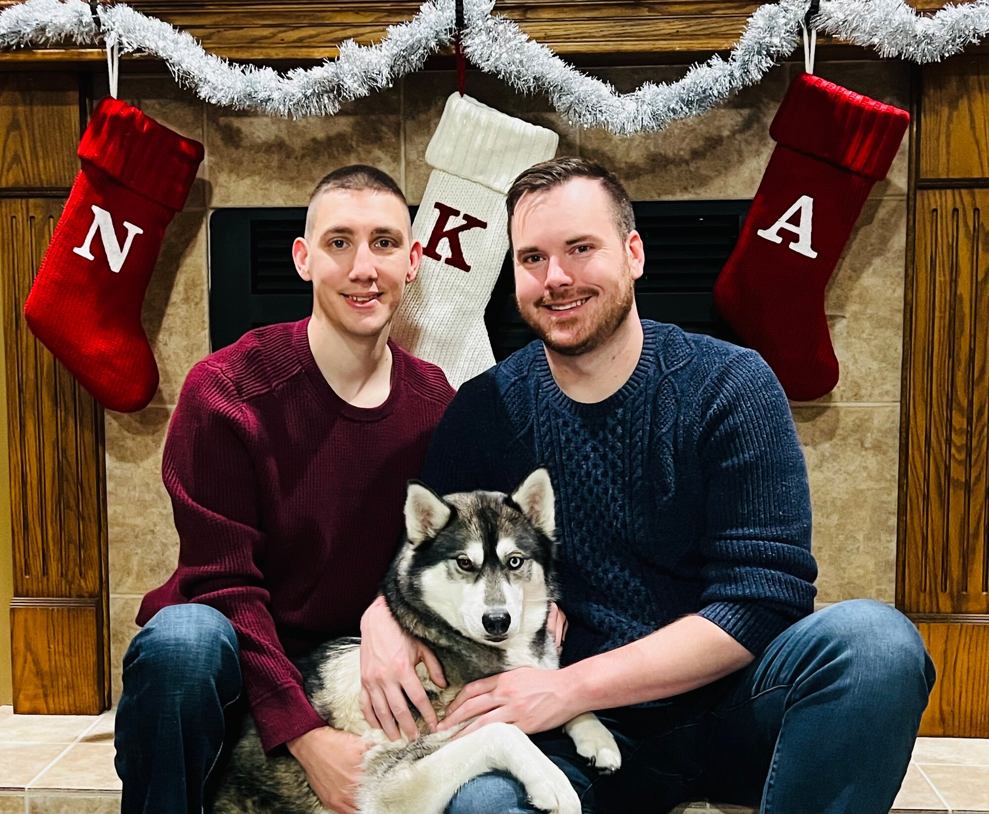 U.S. Air Force Tech. Sgt. Nick Baker, 133rd Medical Group, left, poses for a photograph with his fiancé, Alex Thomas, right and their dog Kōya, Nov. 1, 2022.