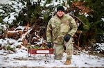 Sgt. 1st Class Michael Sullivan, assistant operations noncommissioned officer with the 734th Regional Support Group, Iowa Army National Guard, kneels next to “Sully’s Lil Red Wagon” at Camp Dodge in Johnston, Iowa, Nov. 17, 2022. He uses the wagon to collect donations for the homeless in the Des Moines area.