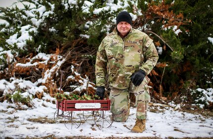 Sgt. 1st Class Michael Sullivan, assistant operations noncommissioned officer with the 734th Regional Support Group, Iowa Army National Guard, kneels next to “Sully’s Lil Red Wagon” at Camp Dodge in Johnston, Iowa, Nov. 17, 2022. He uses the wagon to collect donations for the homeless in the Des Moines area.