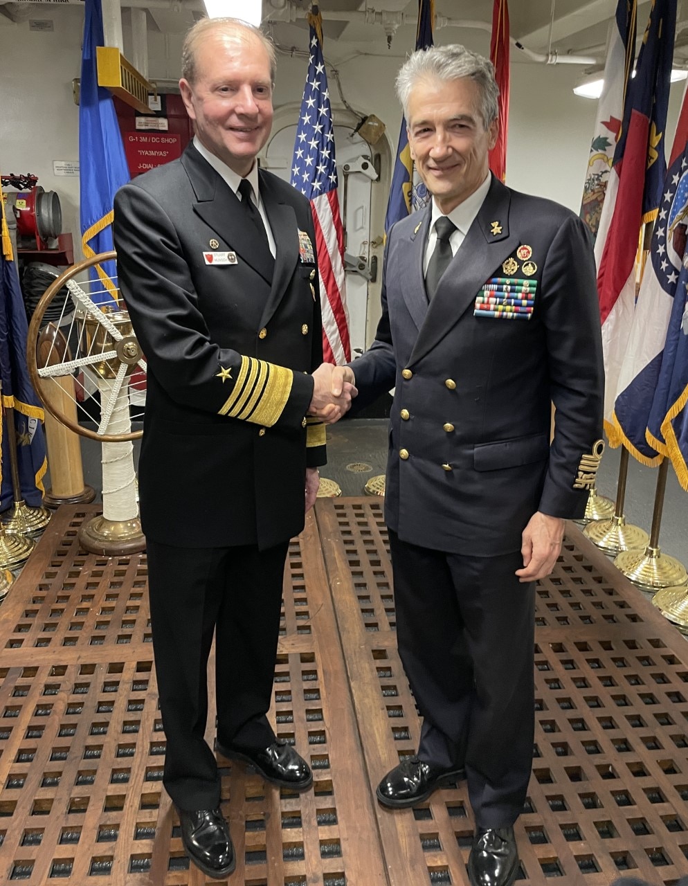Adm. Stuart Munsch, Commander, U.S. Naval Forces Europe-Africa, left, poses for a photo with Italian Head of Navy Adm. Enrico Credendino, right, after a reception for local military and civilian leaders, honoring the U.S.–Italian relationship aboard the Nimitz-class aircraft carrier USS George H.W. Bush (CVN 77) during a scheduled port visit, Nov. 29, 2022.