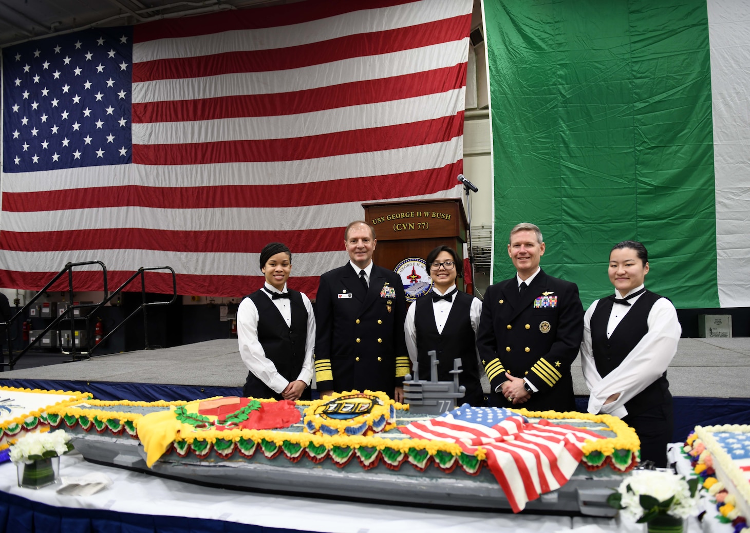 Culinary Specialists assigned to USS George H. W. Bush, pose for a photo with Adm. Stuart Munsch, Commander, U.S. Naval Forces Europe-Africa (NAVEUR-NAVAF) and Allied Joint Forces Command Naples, and Capt. Dave Pollard, Commanding Officer, George H. W. Bush, after a reception for local military and civilian leaders, honoring the U.S.–Italian relationship aboard the Nimitz-class aircraft carrier USS George H.W. Bush (CVN 77) during a scheduled port visit, Nov. 29, 2022.