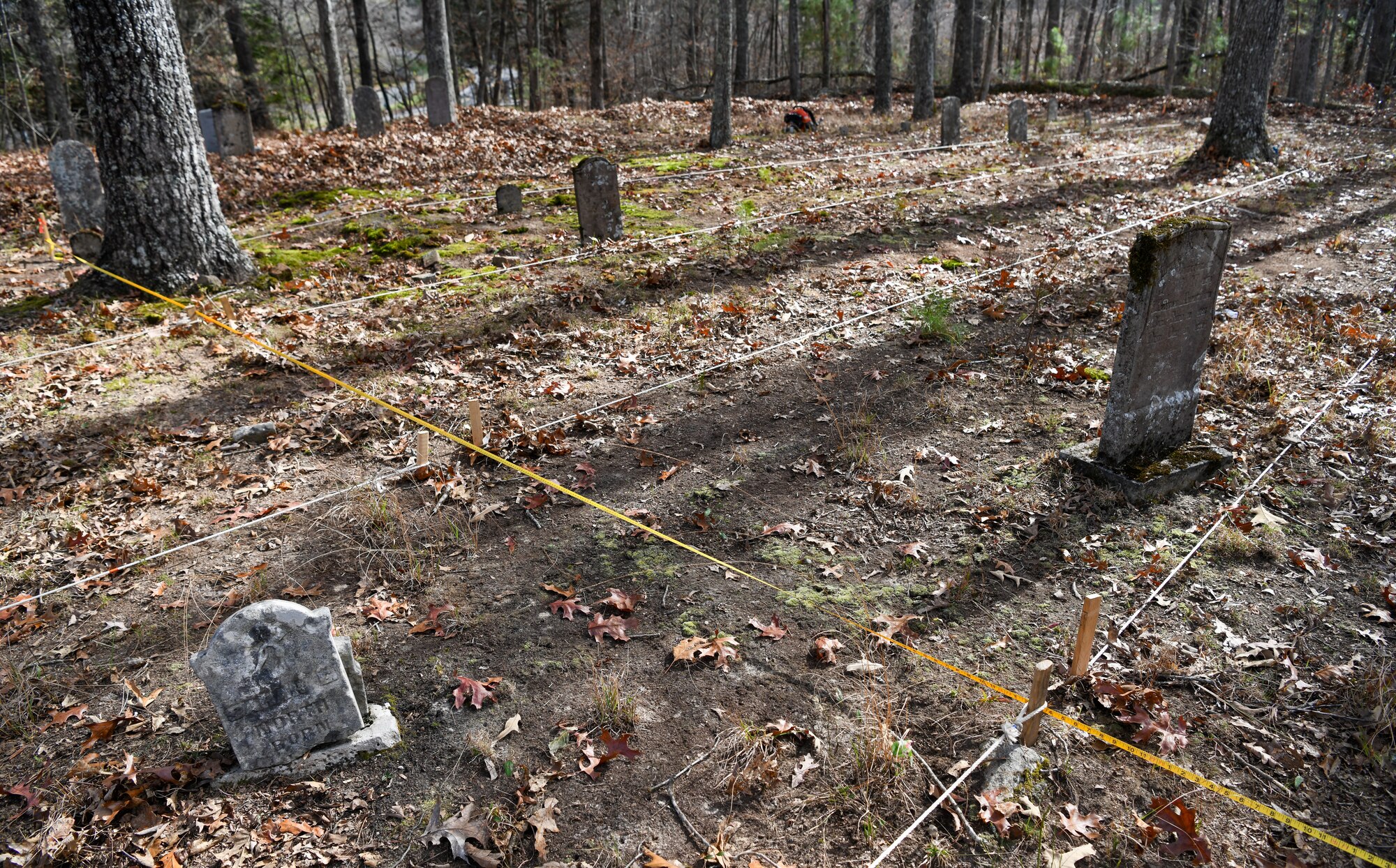 Ropes and tape measures grid off Chapel Hill Cemetery to assist archaeologists as they conduct an electrical resistivity survey Nov. 10, 2022, at Arnold Air Force Base, Tennessee. The survey can help the archaeologists assess what has happened below the surface in an area. This information can then be interpreted to identify possible graves that were never marked or the markers are no longer in place. (U.S. Air Force photo by Jill Pickett)