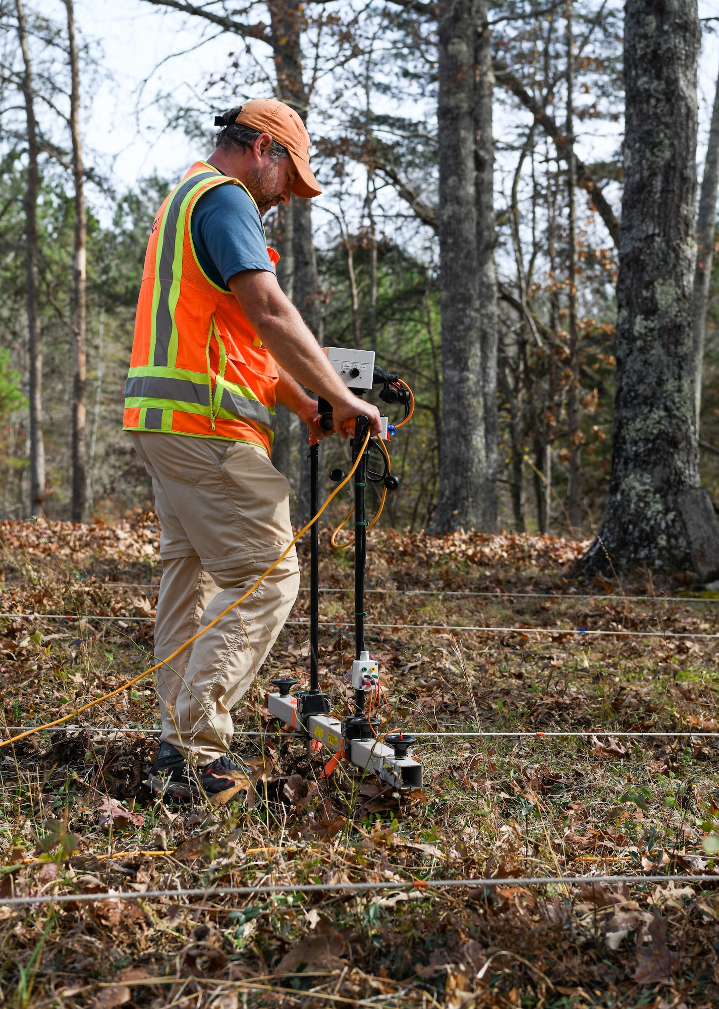 Steve Martin, an archaeologist who specializes in geophysics, uses an electrical resistance meter to survey the Chapel Hill Cemetery at Arnold Air Force Base, Tennessee, Nov. 10, 2022. The survey can help the archaeologists assess what has happened below the surface in an area. This information can then be interpreted to identify possible graves that were never marked or the markers are no longer in place. (U.S. Air Force photo by Jill Pickett)