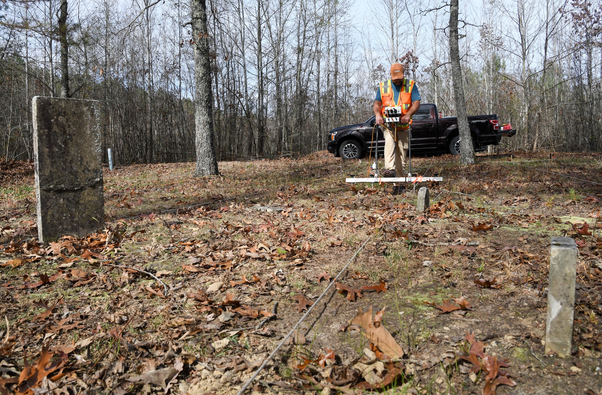 Steve Martin, an archaeologist who specializes in geophysics, uses an electrical resistance meter to survey the Chapel Hill Cemetery at Arnold Air Force Base, Tennessee, Nov. 10, 2022. The survey can help the archaeologists assess what has happened below the surface in an area. This information can then be interpreted to identify possible graves that were never marked or the markers are no longer in place. (U.S. Air Force photo by Jill Pickett)