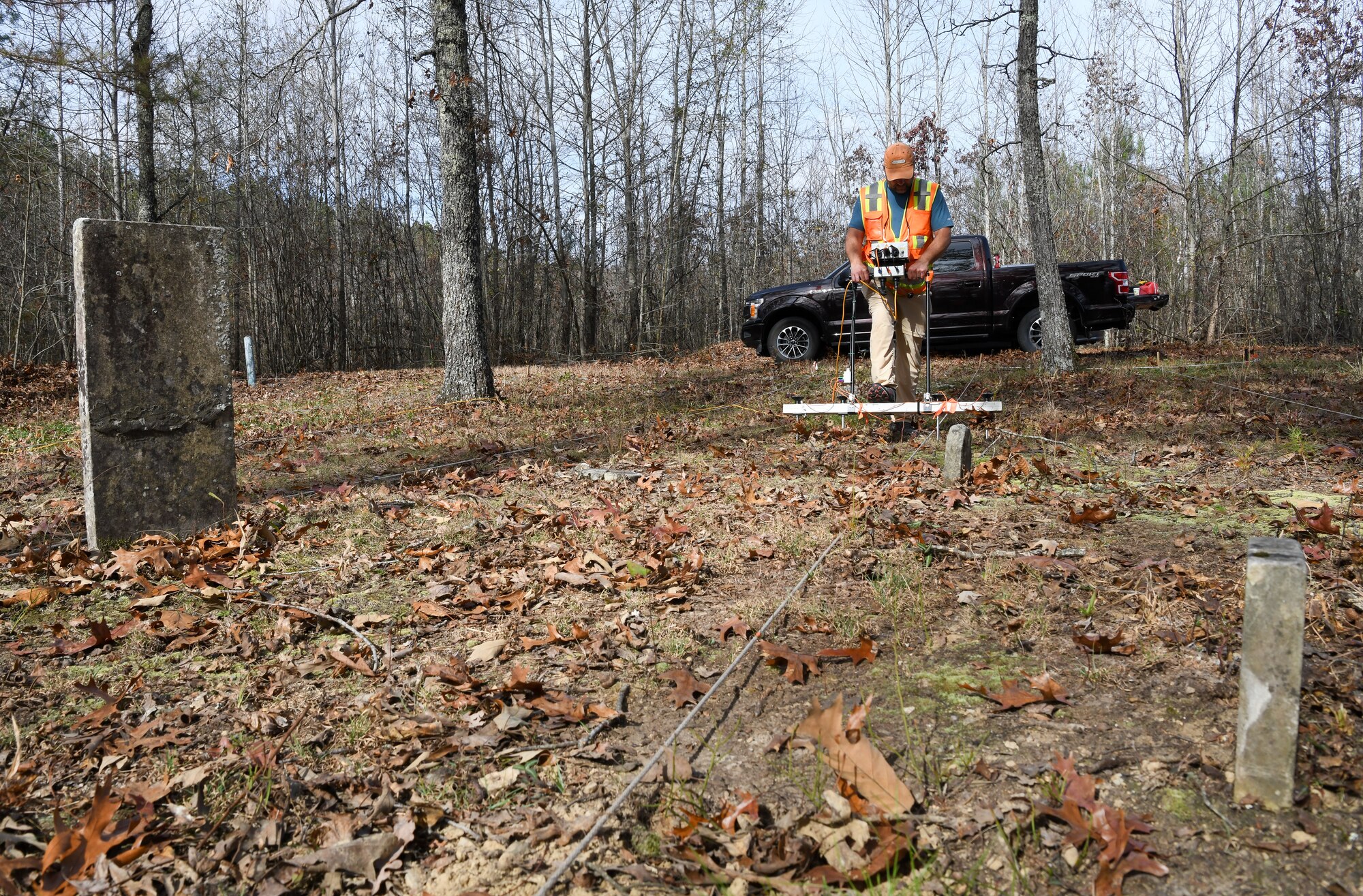 Steve Martin, an archaeologist who specializes in geophysics, uses an electrical resistance meter to survey the Chapel Hill Cemetery at Arnold Air Force Base, Tennessee, Nov. 10, 2022. The survey can help the archaeologists assess what has happened below the surface in an area. This information can then be interpreted to identify possible graves that were never marked or the markers are no longer in place. (U.S. Air Force photo by Jill Pickett)