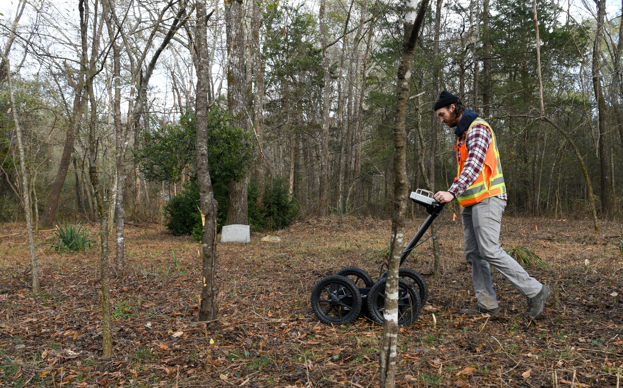 Jacob Jepsen, an archaeologist who specializes in geophysics, operates a ground penetrating radar machine in Rutherford-Shipley Cemetery at Arnold Air Force Base, Tennessee, Nov. 10, 2022. The GPR data gives archaeologists information about what has occurred below the surface to help detect possible grave locations. (U.S. Air Force photo by Jill Pickett)