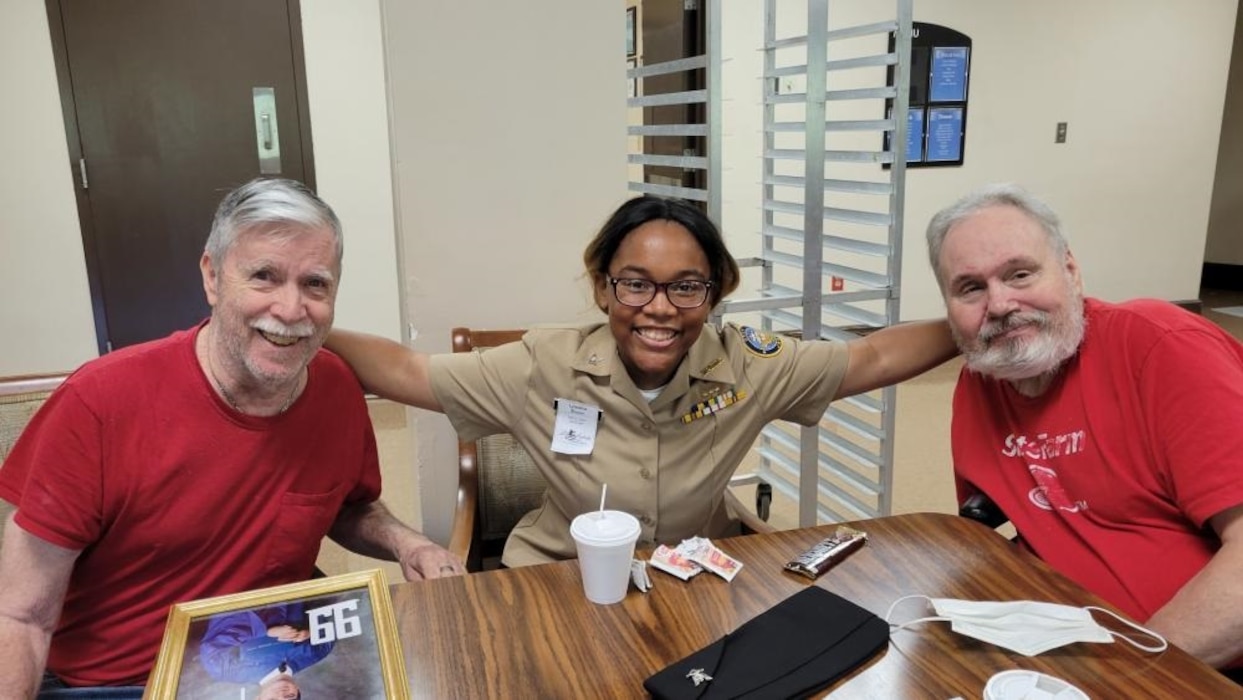 220901-N-LY580-1003 ALEXANDER CITY, Ala. (Sept. 1, 2022) Benjamin Russell High School Navy Junior Reserve Officers Training Corps Cadet Lylaishia Brown visits with veterans at Bill Nichols State Veterans Home. (U.S. Navy photo by James Stockman)