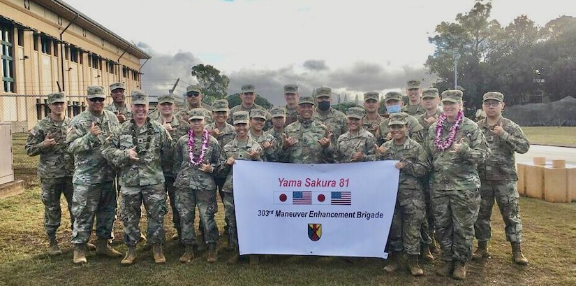 Soldiers from the 9th Mission Support Command's 303rd Maneuver Enhancement Brigade pose for a group photo during the commencement of Exercise Yama Sakura 81 at Schofield Barracks, HI. The Soldiers will serve as a subordinate unit for the headquarters element operating out of Camp Itami, Japan.