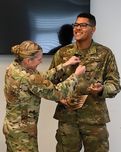 U.S. Air Force Col. Catherine “Cat” Logan, commander of Joint Base Anacostia-Bolling and the 11th Wing, places a new rank patch on Tech. Sgt. Brandon Miller, 11th Civil Engineer Squadron power production supervisor, after awarding him a Strips for Exceptional Performers promotion, Nov. 23, 2022, at JBAB, Washington D.C. The STEP promotion immediately elevated him from the rank of staff sergeant to technical sergeant. (U.S. Air Force photo by Airman Bill Guilliam)